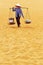 A peddler on the sand dunes
