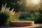 A pedestal for displaying products in a beautiful garden with bushes of blooming flowers. Empty podium in a natural