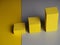 Pedestal squares shadows on a yellow and gray background