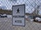 Pedestrian Access sign attached to a chain link fence, blocking off a construction site near a parking lot