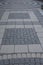 The pedestrian area is cobbled with gray stone. Geometric pattern, vertical photography texture