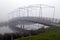 Pedestrian and bicycle bridge in a nature reserve and in the fog