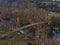 Pedestrian and bicycle suspension bridge crossing Neckar river near Hessigheim, Germany on a sunny day in autumn with trees.