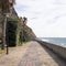 Pedestrian boardwalk under the sun in front of the Atlantic ocean water