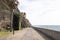 Pedestrian boardwalk under the sun in front of the Atlantic ocean water, Madeira