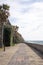 Pedestrian boardwalk under the sun in front of the Atlantic ocean water, Madeira