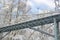 Pedestrian bridge across a ravine in a beautiful snowy day in winter