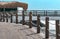 Pedestrian bridge along the coast with a fence with a rope. Sea summer landscape background