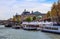 Pedestrian bridge Passerelle LÃ©opold-SÃ©dar-Senghor over Seine river, boats and historic buildings of Paris France