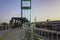 Pedestrian bridge spans over busy city street allowing for safe pedestrian travel