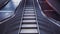 Pedestrian crossing escalator goes without people. Automatic stairs moving up at airport.