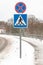 Pedestrian crossing road sign with snow