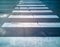 Pedestrian crossing zebra on wet asphalt