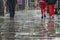 Pedestrian feet walking in the rain in Chiswick street