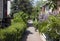 Pedestrian path through detached houses and green gardens. peaceful ideal living spaces.