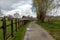 Pedestrian road through the fields at the Flemish countryside in summer