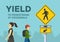 Pedestrian safety and car driving rules. Close-up view of pedestrians on the city road. Yield to pedestrians at crosswalk sign.