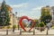 Pedestrian street in the old residential center of the city. Bench of love in the shape of a heart with flower pots.