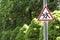 Pedestrian triangular sign on the background of trees