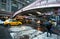 A pedestrian with an umbrella walks by traffic at Grand Central Station in New York City.