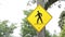 pedestrian walking crossing yellow diamond sign with black print illustration..