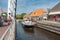 Pedestrians and bikers waiting for opened bridge for passing yachts