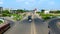 Pedestrians and bikes, cars passing under the bridge on chennai, India