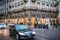 Pedestrians and car traffic on a typical shopping street in downtown Milan