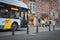 Pedestrians cross the street. The bus stopped for pedestrians