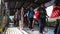 Pedestrians pass by an elevated walkway