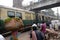 Pedestrians, rickshaws, cyclists waiting on railroad crossing in Kolkata