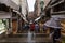 Pedestrians seek shelter by running down a footpath during a rain storm near the Rialto market in Venice