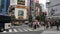 Pedestrians wait to cross at a busy intersection in Tokyo