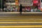 Pedestrians wait to cross the street