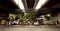 Pedestrians walk by street food stalls under a bridge in Bangkok.