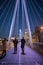 Pedestrians walking on a bridge above the River Thames during nighttime