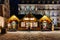 Pedestrians walking in front of Christmas Market stalls chalet i