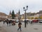 Pedestrians walking incentral square with Christmas tree in place Kleber a few