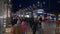 Pedestrians walking at Princes Street Edinburgh at night