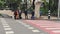 Pedestrians wearing masks wait for a green traffic light. Pedestrians zebra crossing.