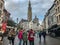 Pedestrians on wide cobbled streets in front of Cathedral of Our