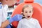 Pediatric dentist checks caries in a little girl. beautiful girl is smiling in dentist`s office. concept is a children`s medical