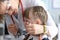 Pediatric dentist examines teeth little girl