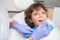 Pediatric dentist examining a little boys teeth in the dentists chair