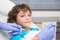 Pediatric dentist examining a little boys teeth in the dentists chair