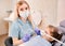 Pediatric dentist examining little girl teeth in dental office.