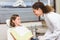 Pediatric dentist examining little girls teeth in the dentists chair