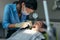 Pediatric dentist inspecting teeth of boy patient