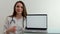 pediatric doctor therapist showing thumb up monitor laptop smile space for advertising dentist cardiologist