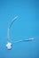 A pediatric endotracheal tube isolated on blue background